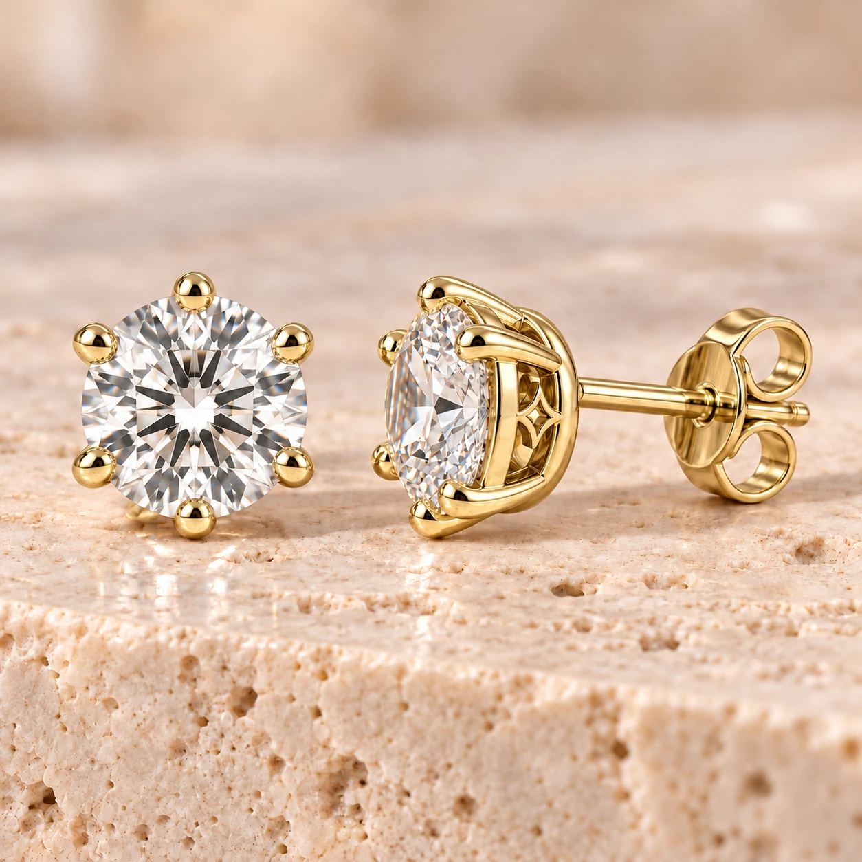 Round brilliant solitaire stud earrings in yellow gold